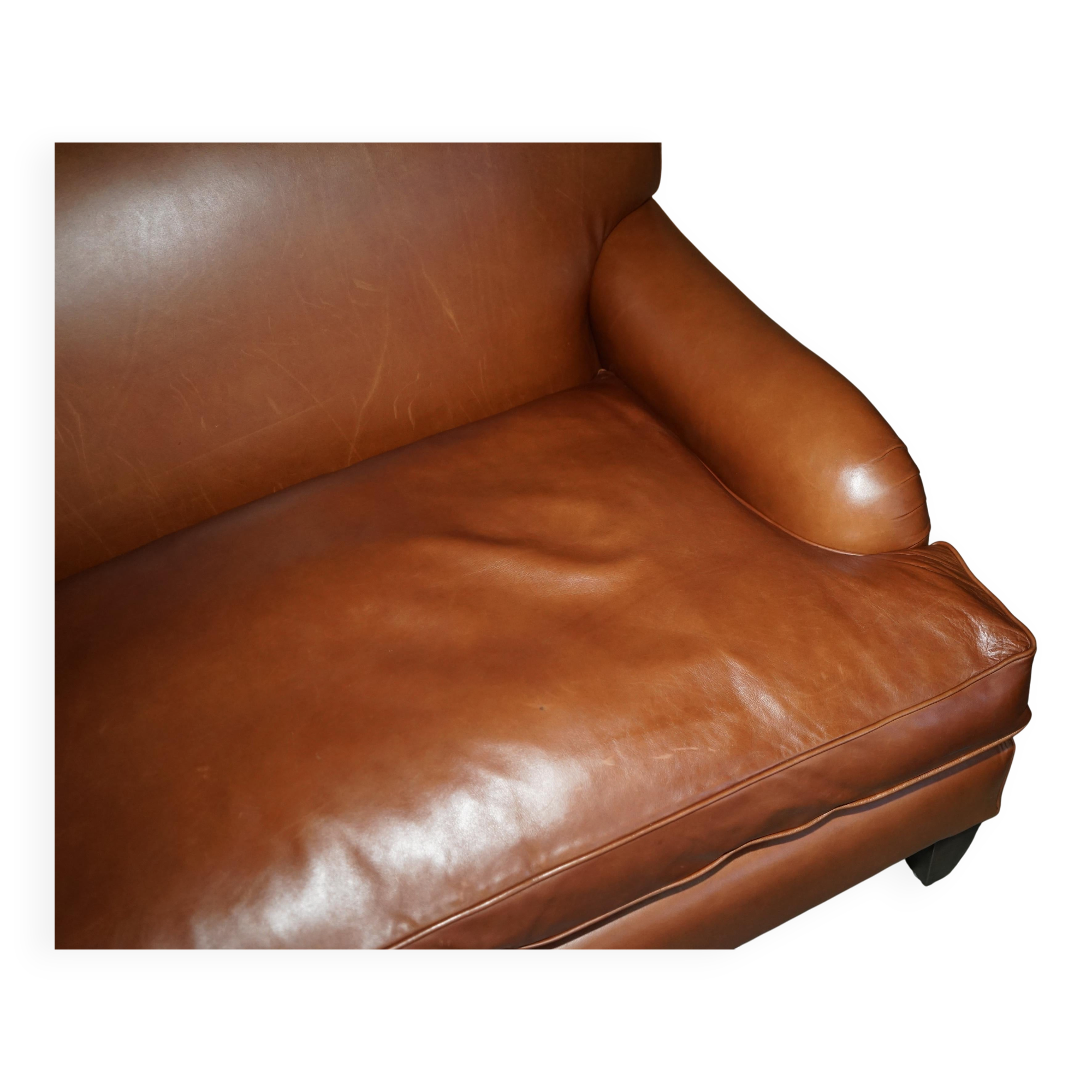 Two-seater leather armchair in Howard style by George Smith.