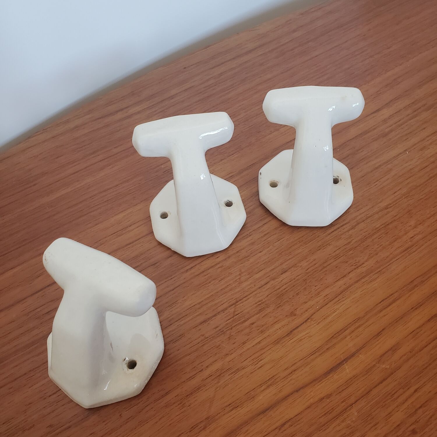 Trio of white porcelain hooks