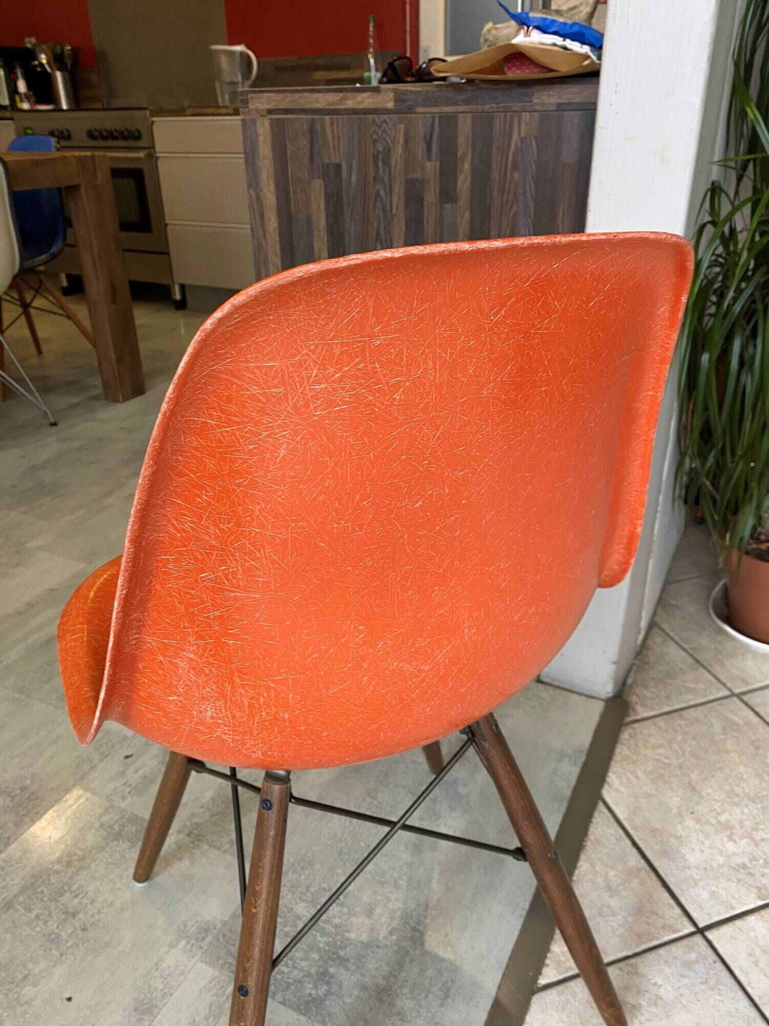 A vintage 70s Eames Herman Miller DSW Fiber Red Orange Dowel Walnut Chair