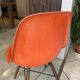 A vintage 70s Eames Herman Miller DSW Fiber Red Orange Dowel Walnut Chair