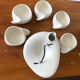 Teapot and cups in contemporary ceramic