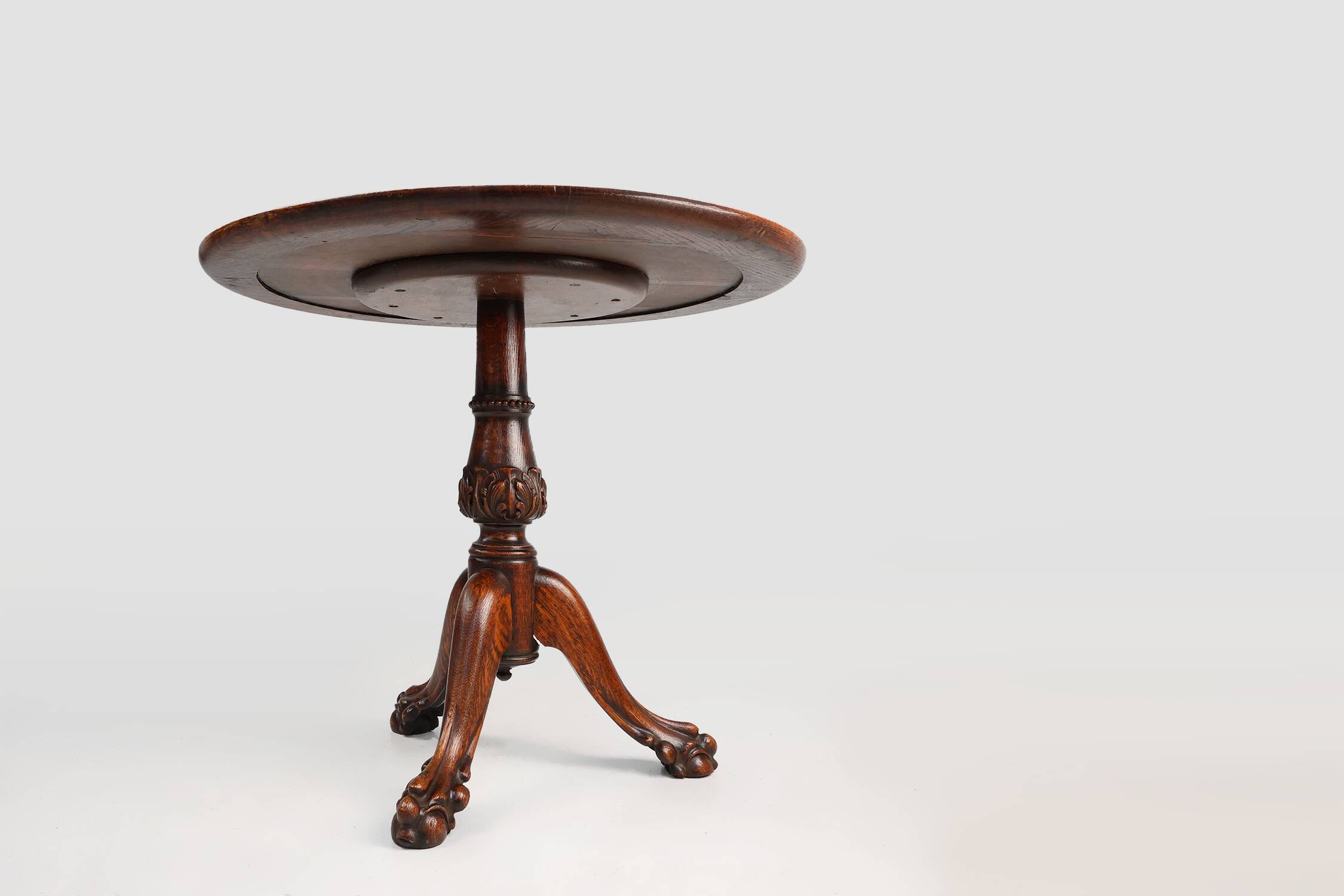 Antique English hand carved circular oak side table with lions head feet