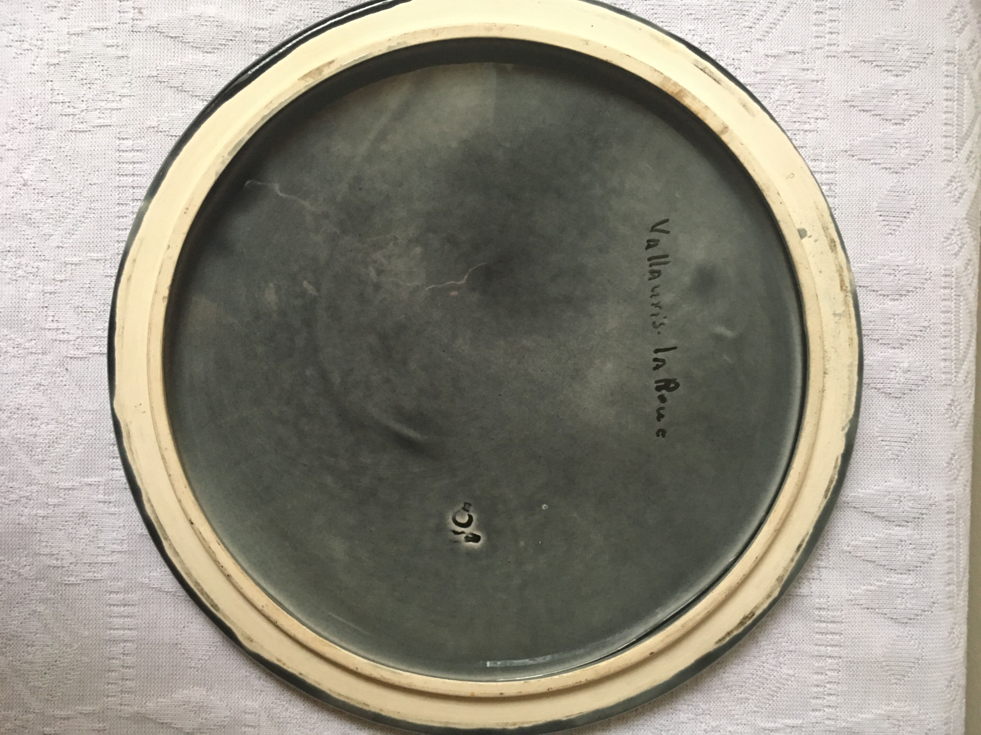 Underside of flat ceramic pink flowers La Roue de Vallauris