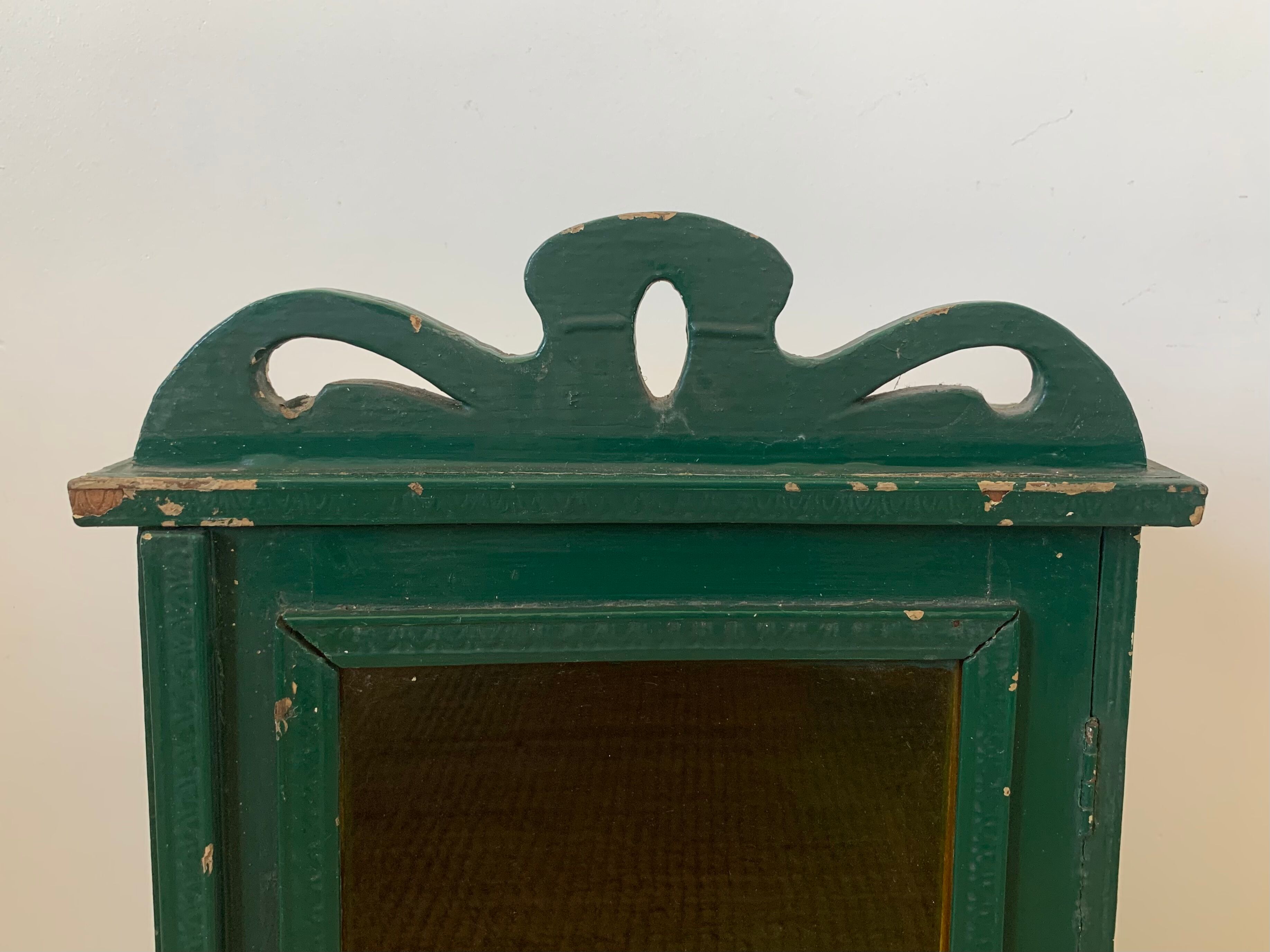 Wall vitrin with pediment