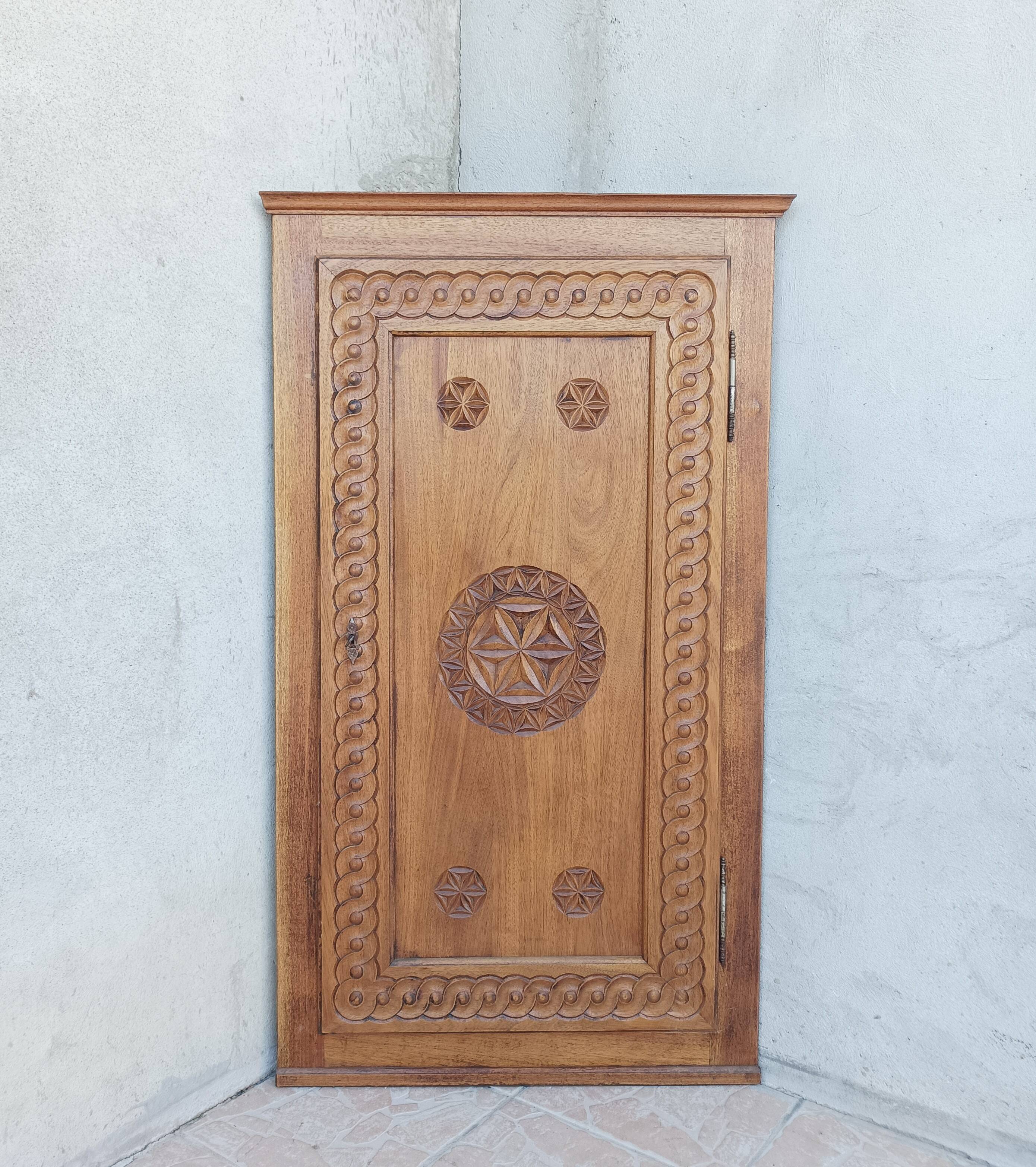 Corner cabinet in carved walnut, Savoyard style.