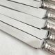 12 antique silver-plated knives with acanthus shell decoration and stainless steel blades.