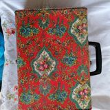 Old suitcase, red cashmere fabric, bohemian folk