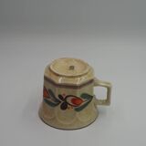 Speckled cup with flower pattern