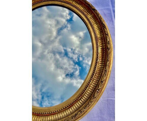Oval wall mirror in gilded wood late nineteenth