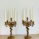 Solid bronze candlesticks decorated with putti, acanthus leaves and lion heads