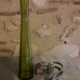 Large decanter with large glass neck and silver metal handle.
