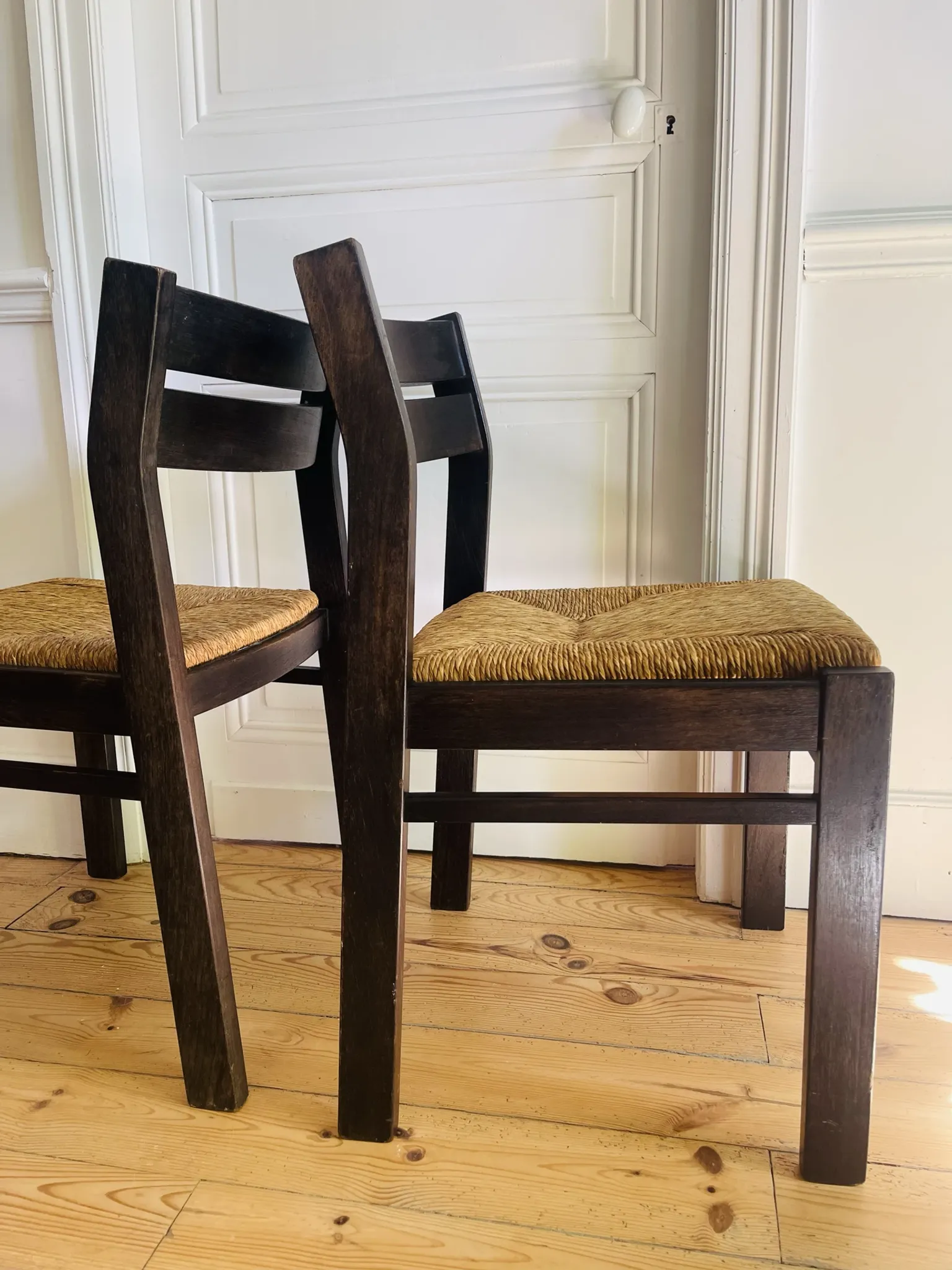 Pair of straw-seated wooden chairs in the regain style.