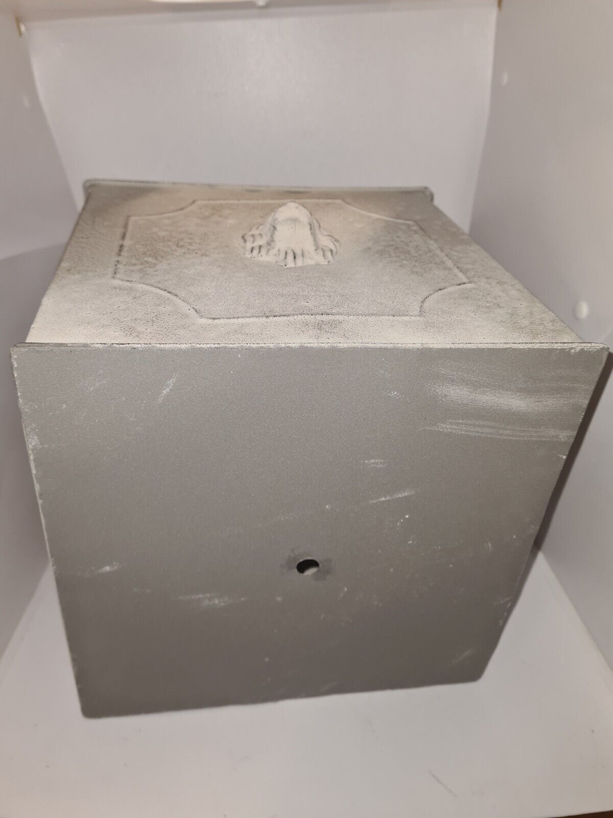 Square planter with a patinated iron lion's head