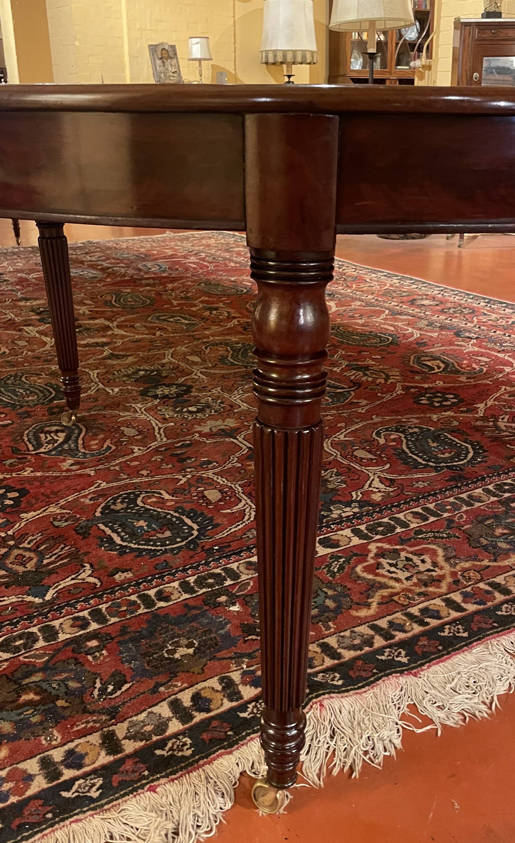 Extensible dining table from the Louis XVI period in mahogany with a banded top.