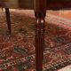 Extensible dining table from the Louis XVI period in mahogany with a banded top.