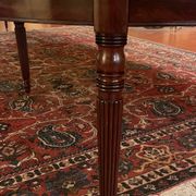 Extensible dining table from the Louis XVI period in mahogany with a banded top.