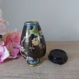 Small black cloisonné vase decorated with yellow and pink cherry blossoms, vase on wooden base