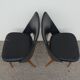 2 chairs in black skai compass legs Louis Paolozzi
