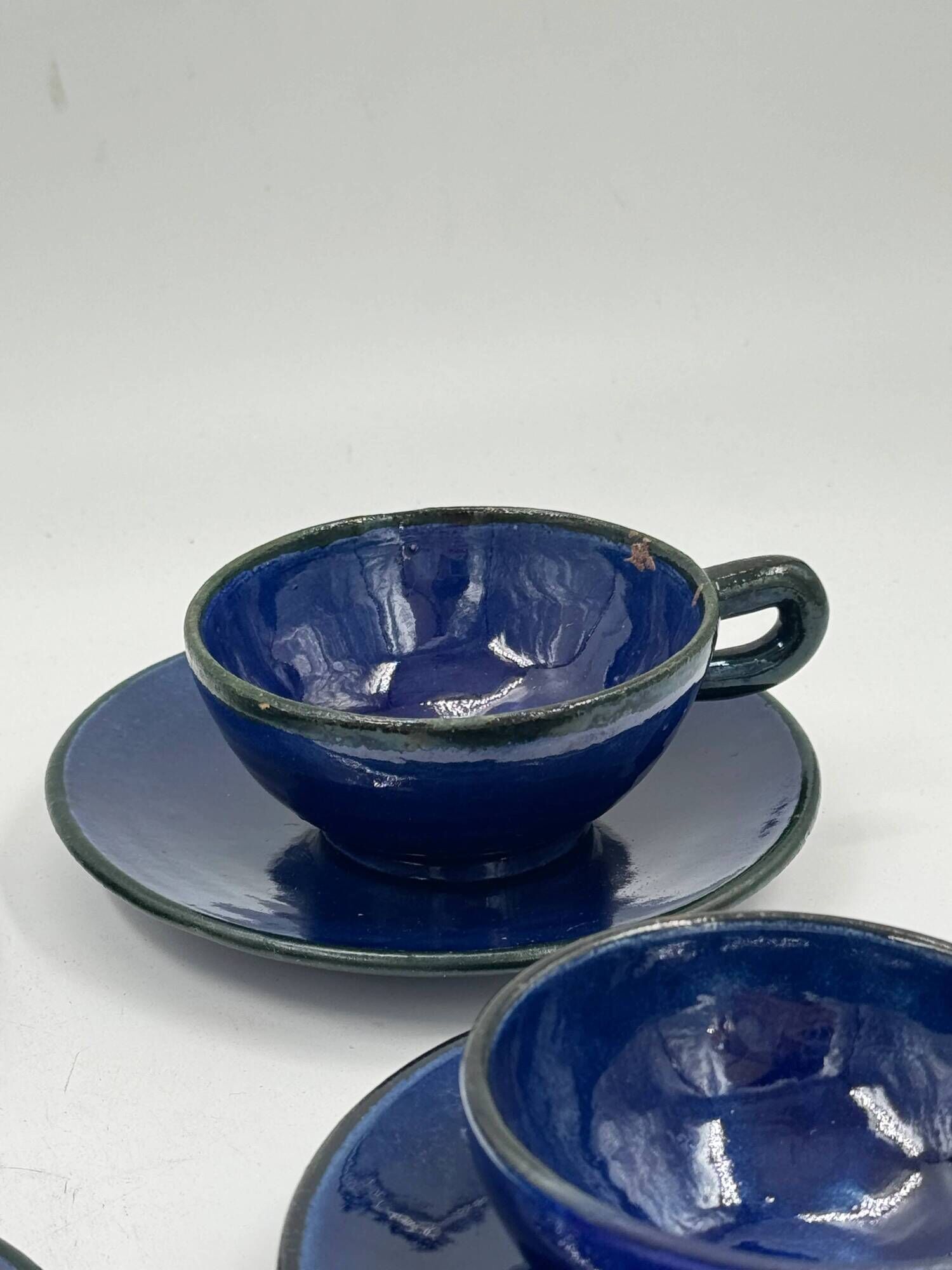 Set of 4 vintage ceramic cups and saucers, cobalt blue glaze.