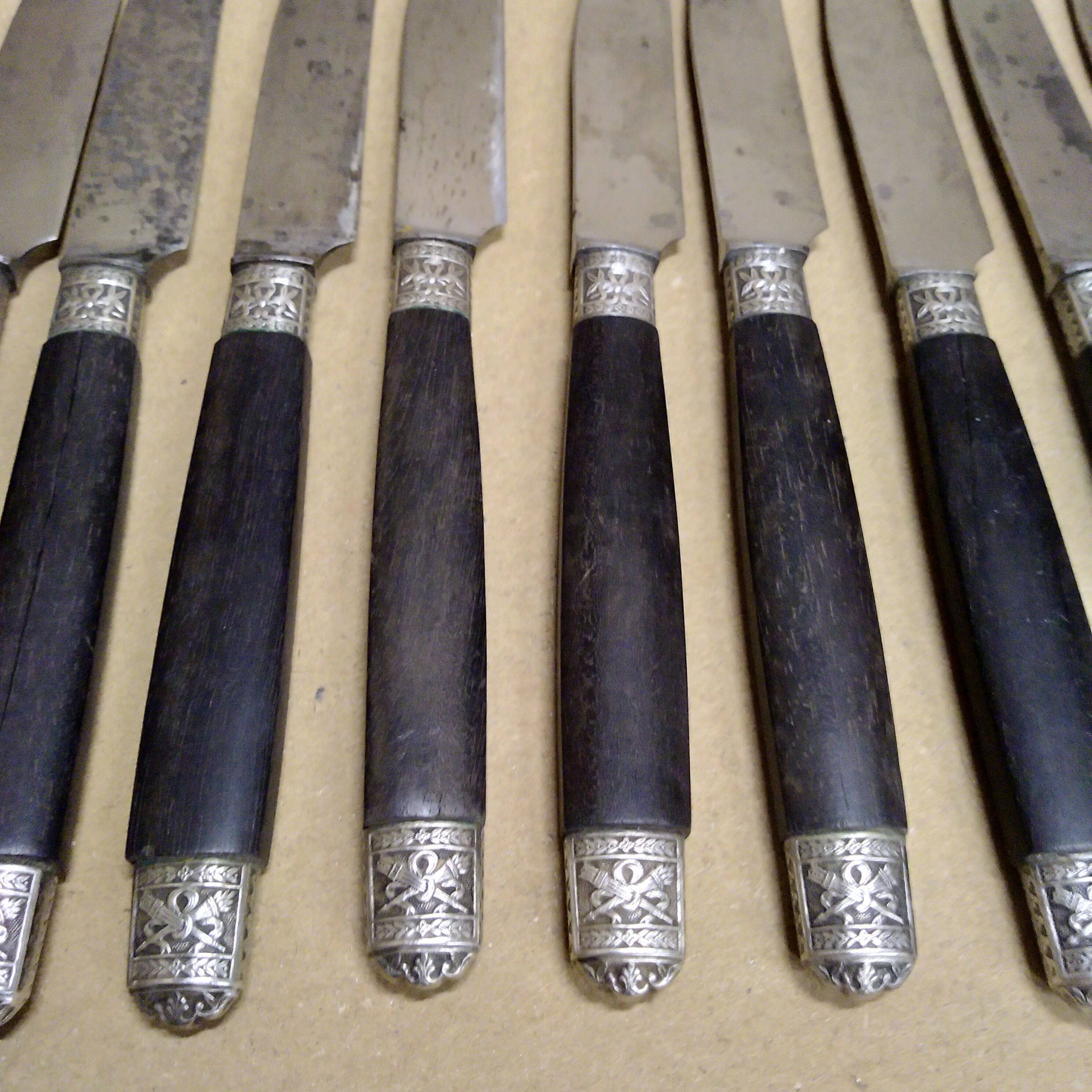 12 Silver dessert knives, ebony, steel, late 19th century
