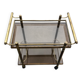 Mid Century Modern bar cart with 2 levels in brass and tinted glass.