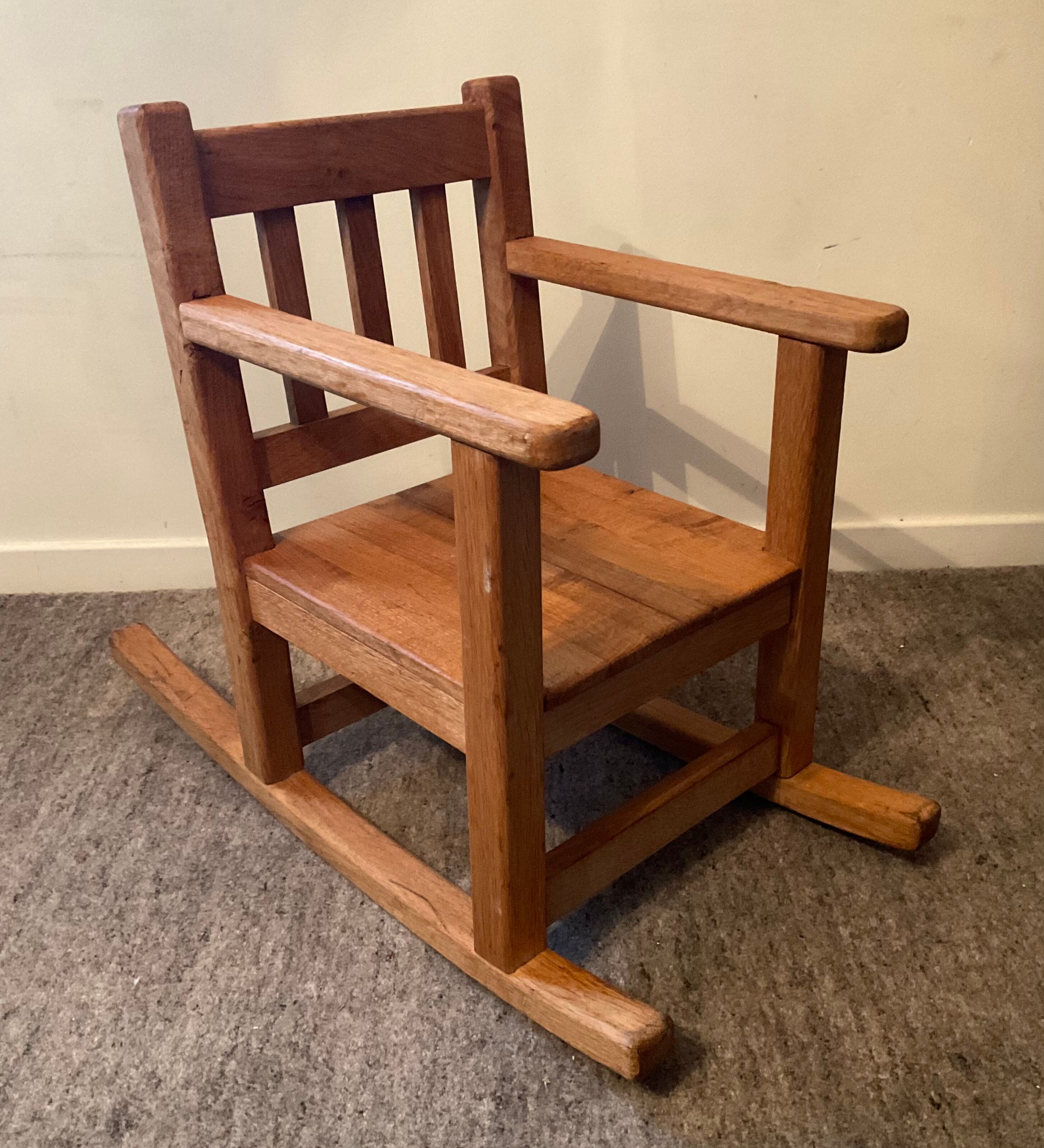 Old children's rocking chair in solid wood