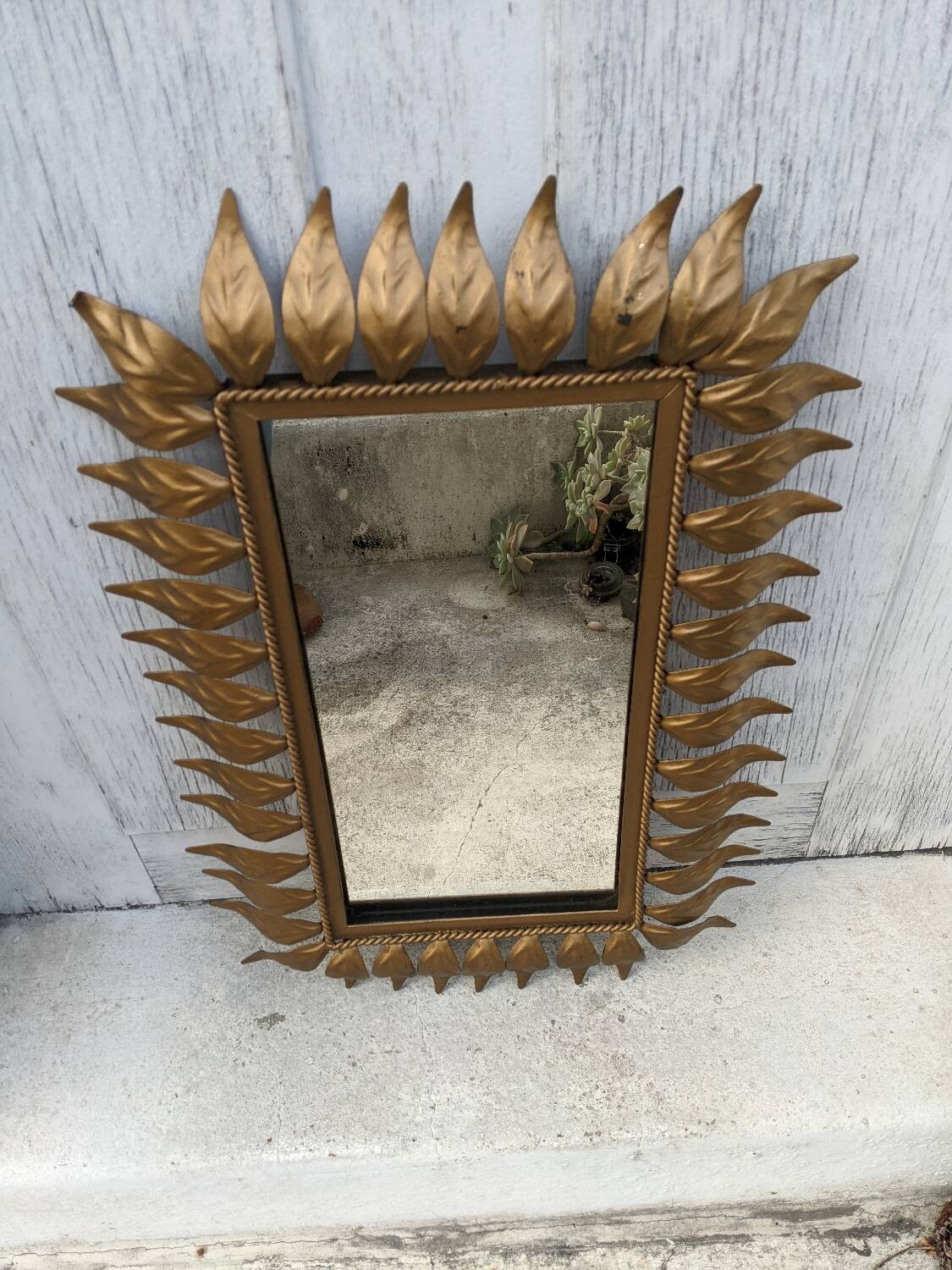 Vintage gold metal mirror with leaves from the 1950s.