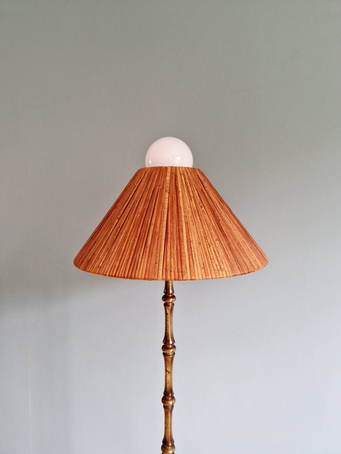 Brass floor lamp with rattan shade, 1950s-60s.