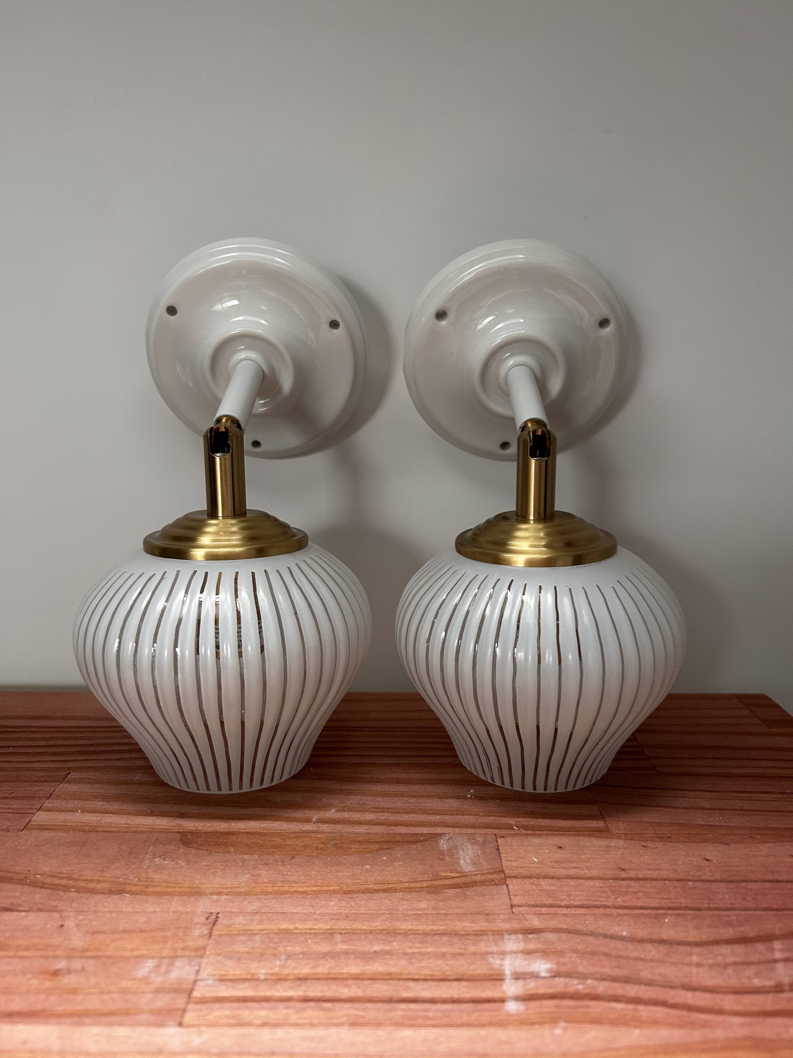 Pair of vintage white globe tilting wall sconces