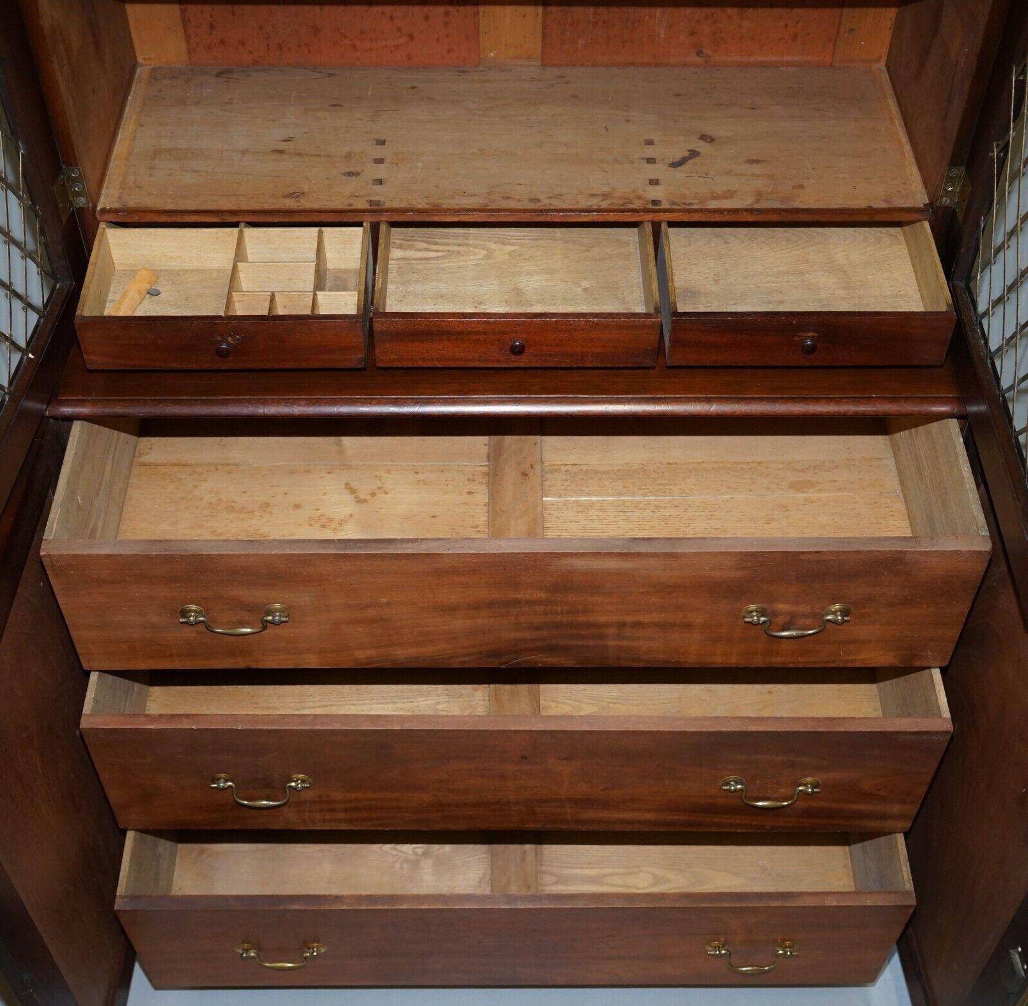 19th-century hardwood library with bronze metal doors and a chest of drawers.
