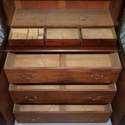 19th-century hardwood library with bronze metal doors and a chest of drawers.