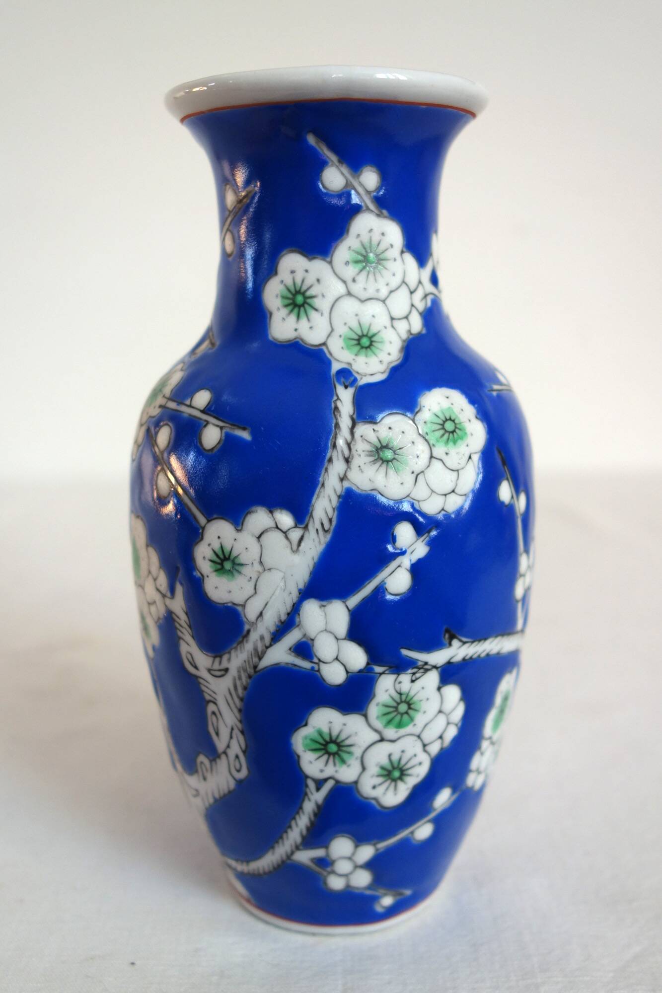 Old blue vase with vintage porcelain cherry blossoms