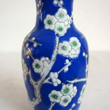 Old blue vase with vintage porcelain cherry blossoms