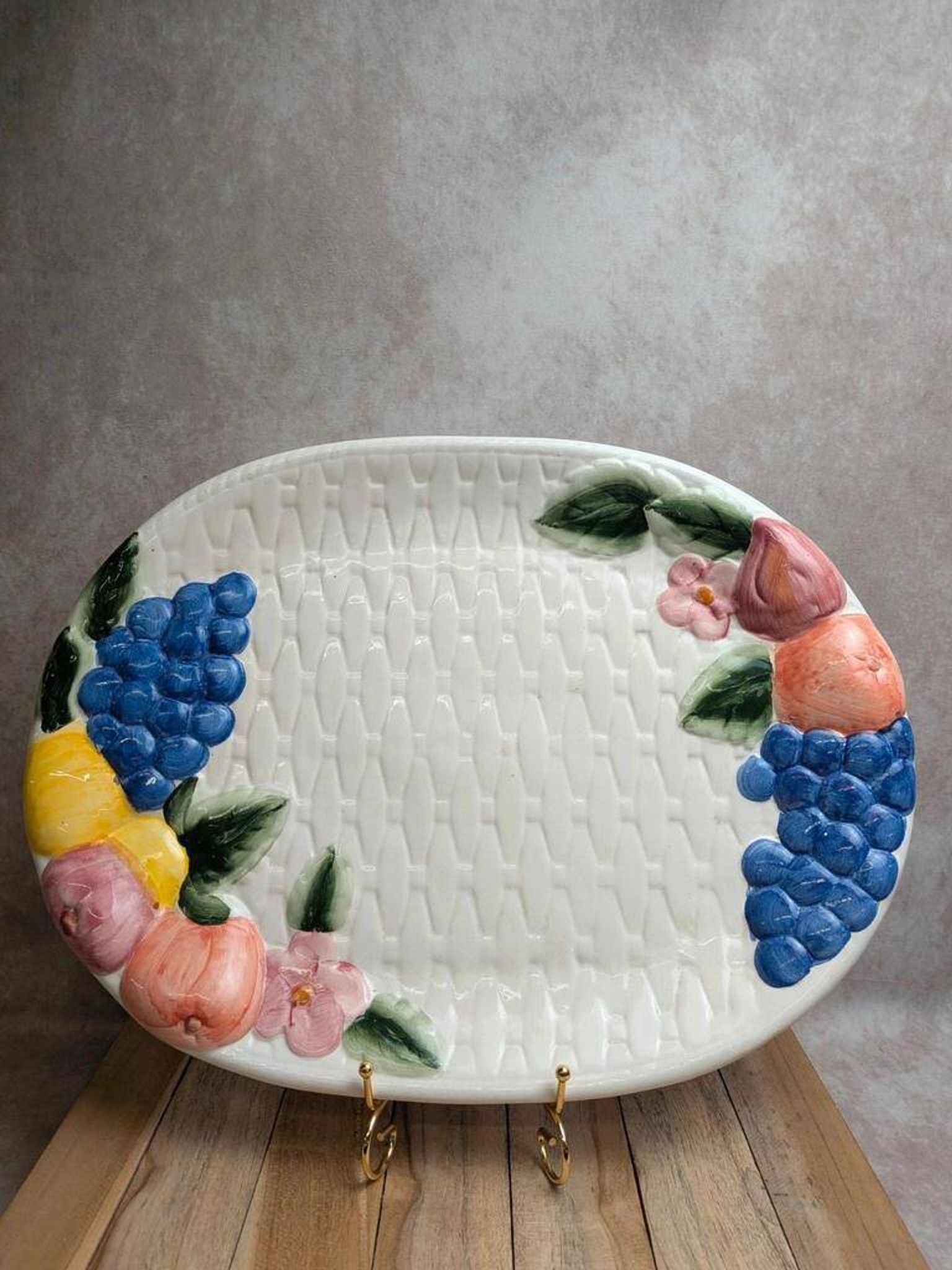 Vintage oval serving dish in majolica – Relief fruit decoration and woven basket design.