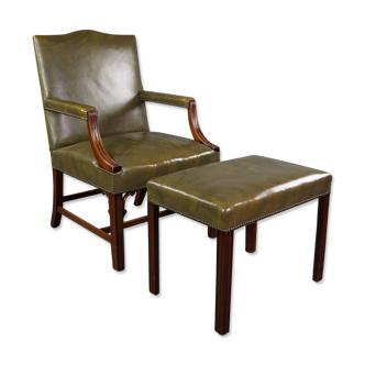 Elegant armchair and footrest in English green leather