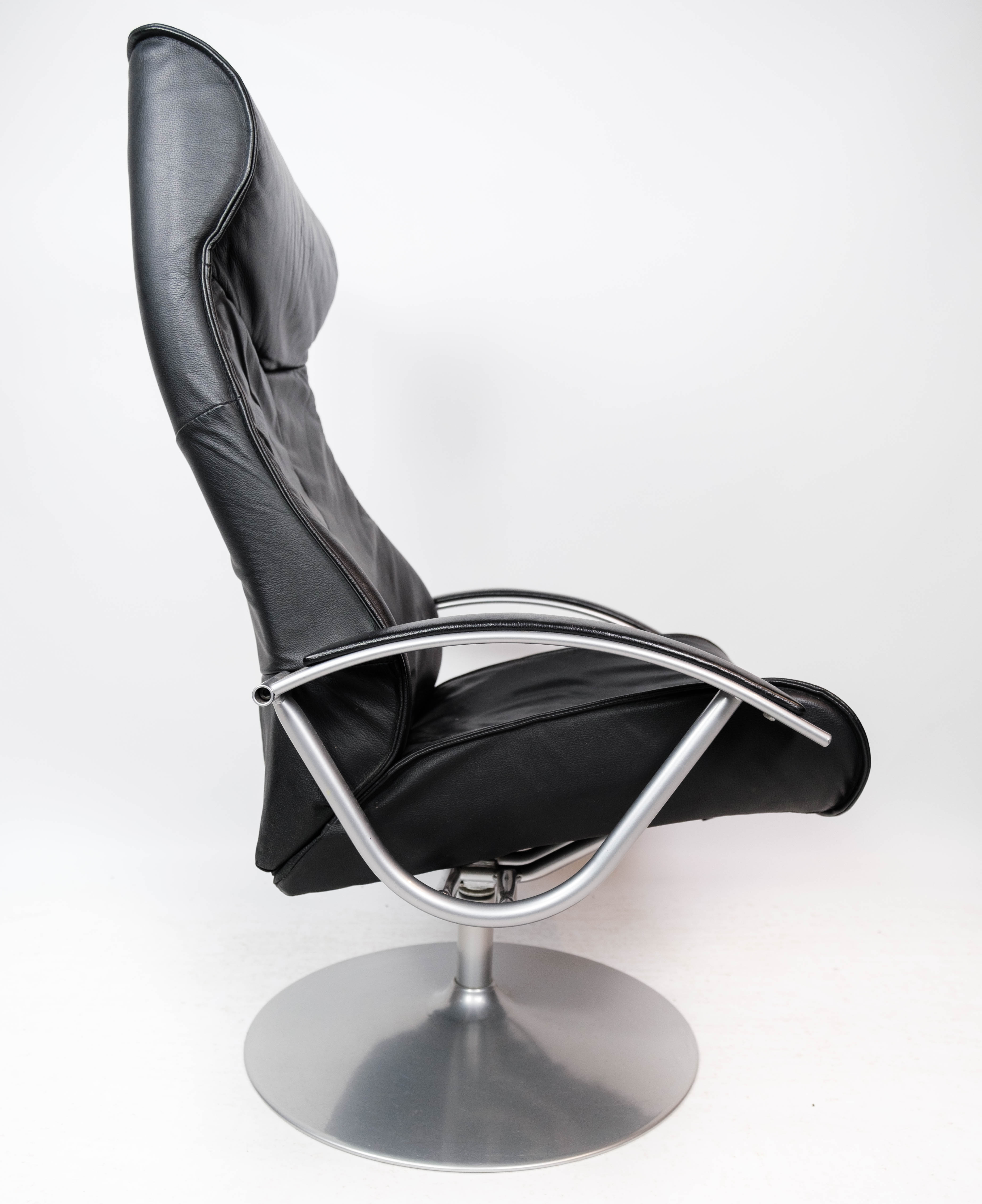 Easy chair with stool upholstered with black leather of Danish design, 1970s