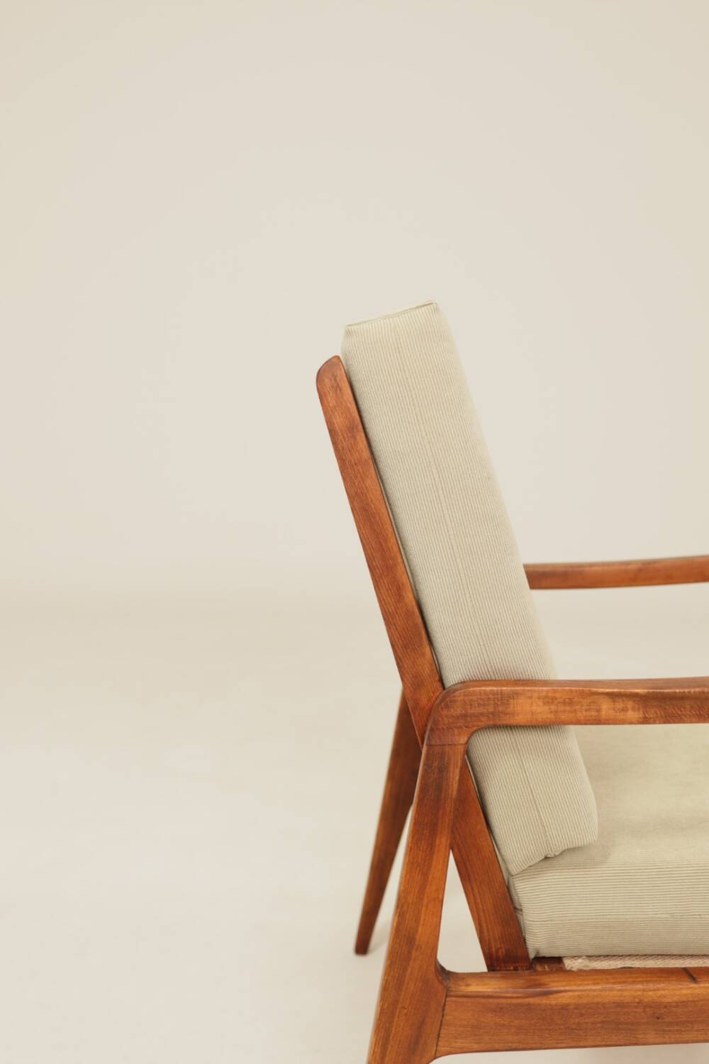 Vintage armchair in olive corduroy with a wooden frame.