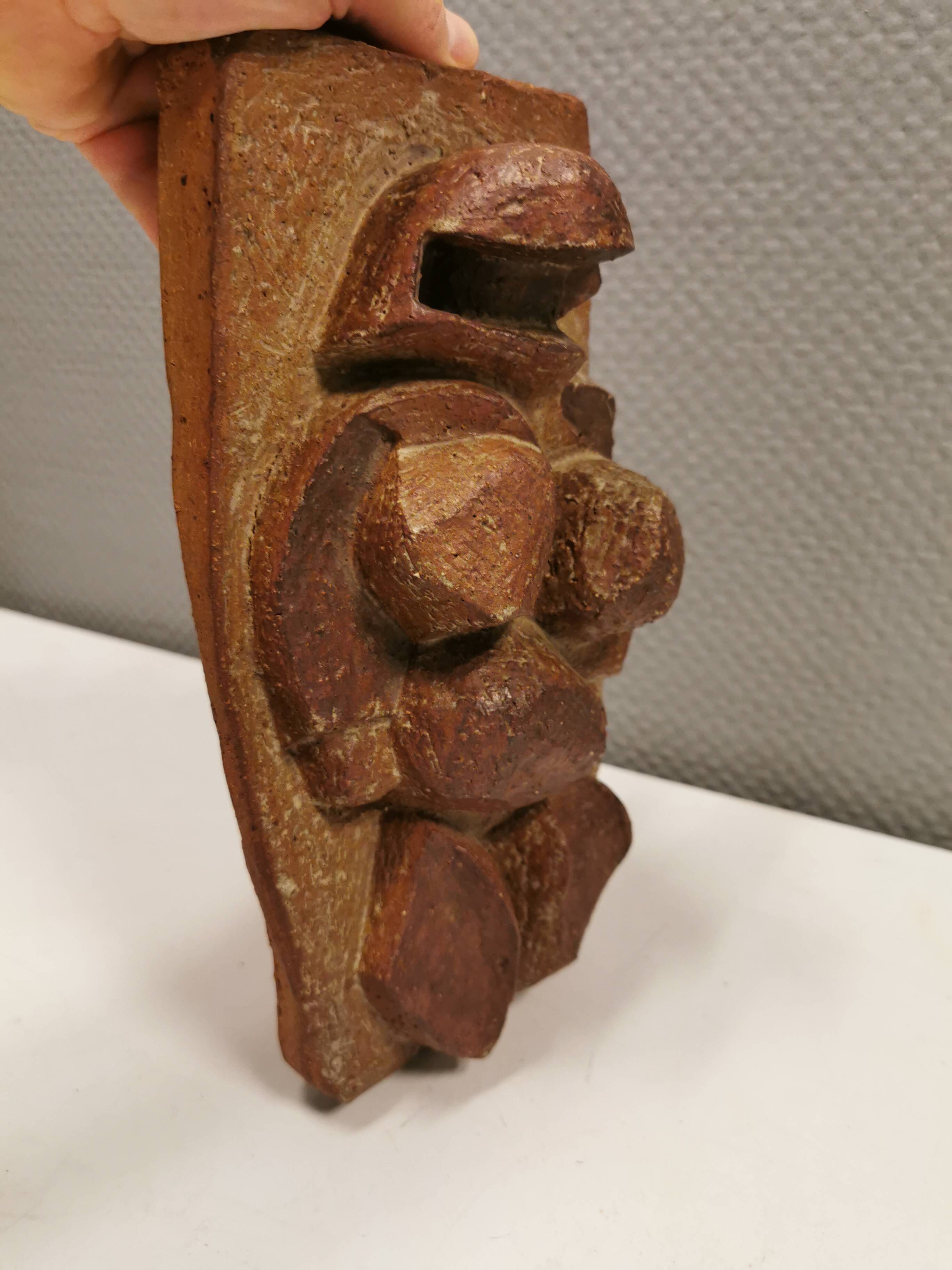 Ceramic relief portraying a lady. Emerging out of the background.