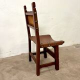Spanish chair in leather and carved wood, 1950s/60s.