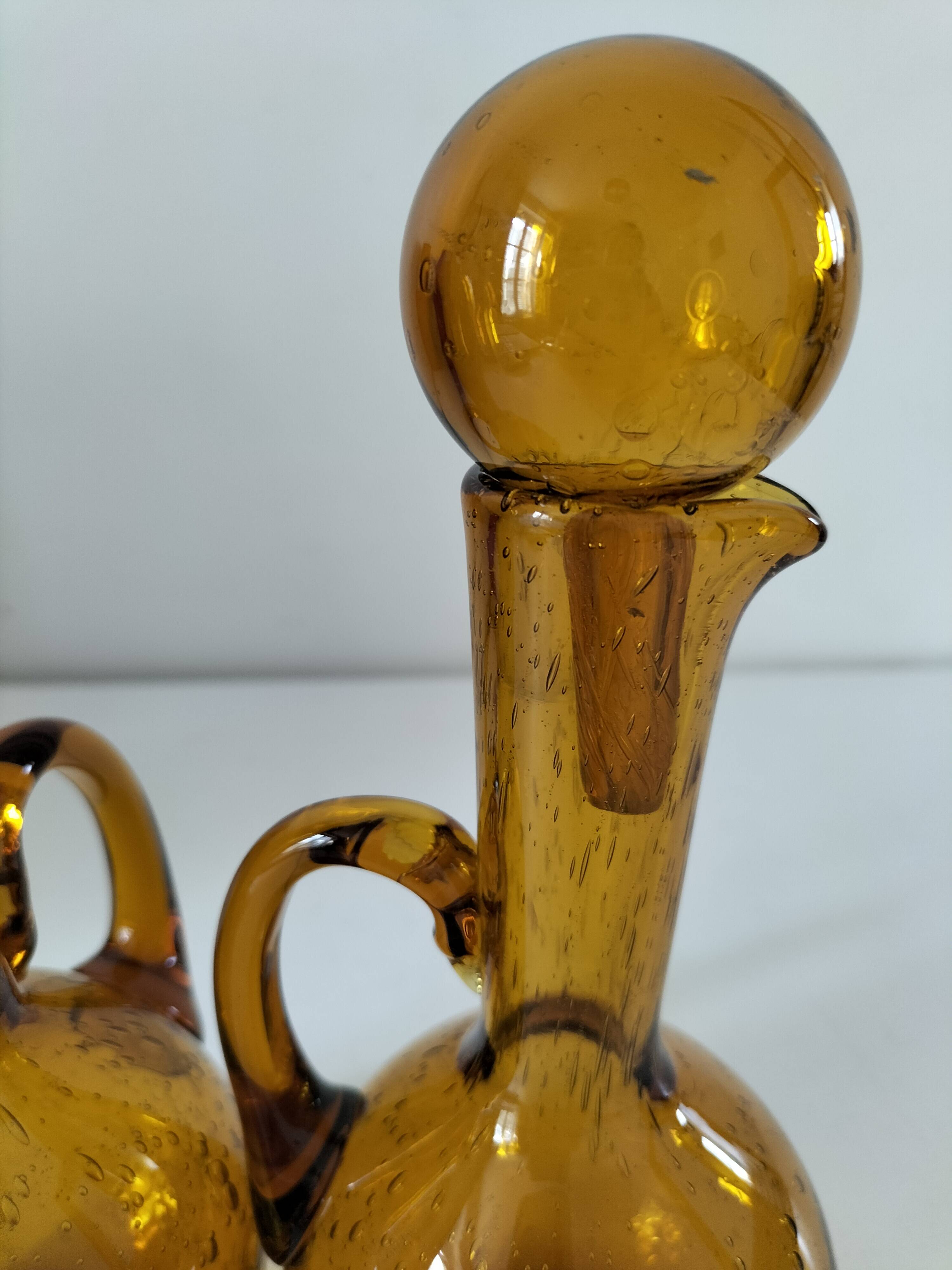 Duo of blown glass carafes – Biot signed – Bubbled amber glass