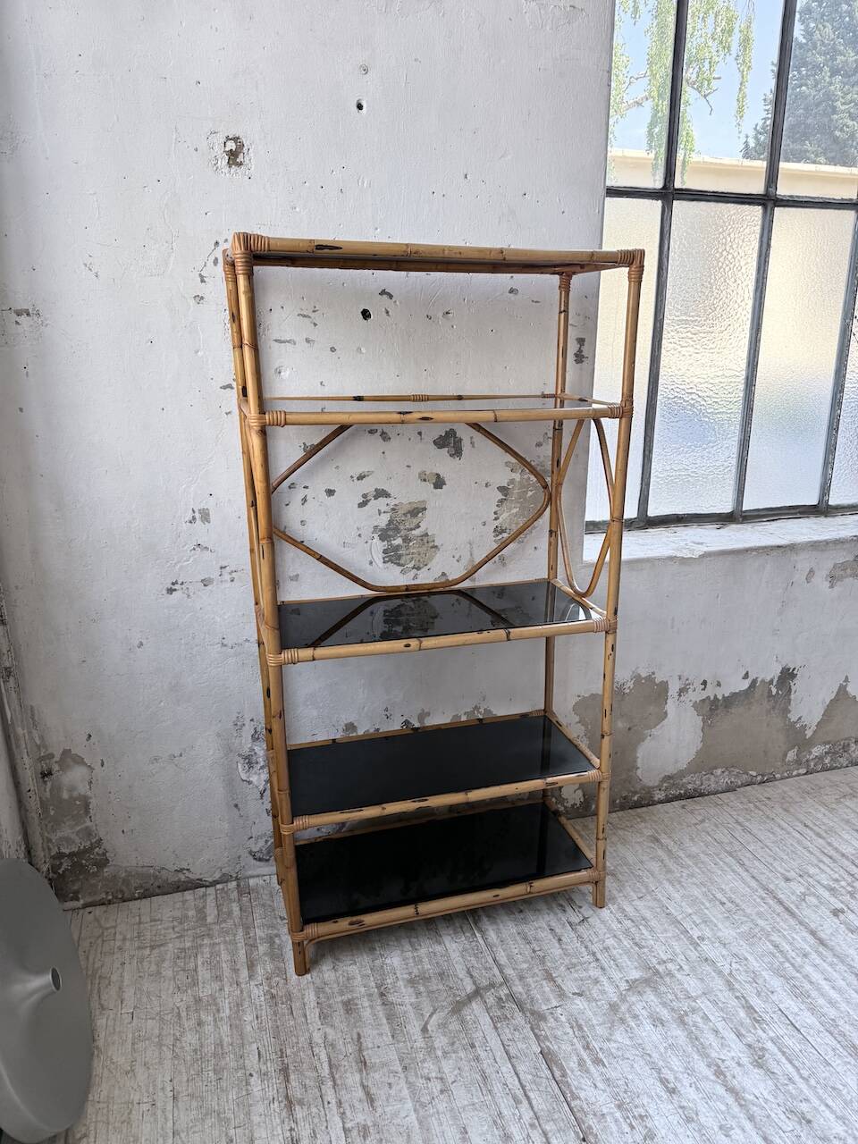 Rattan bookshelf and black glasses