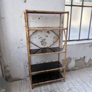 Rattan bookshelf and black glasses