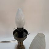 Old bronze or brass table lamp from the early 20th century with white streaked flame glass globe