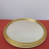 Round mirror in gold metal