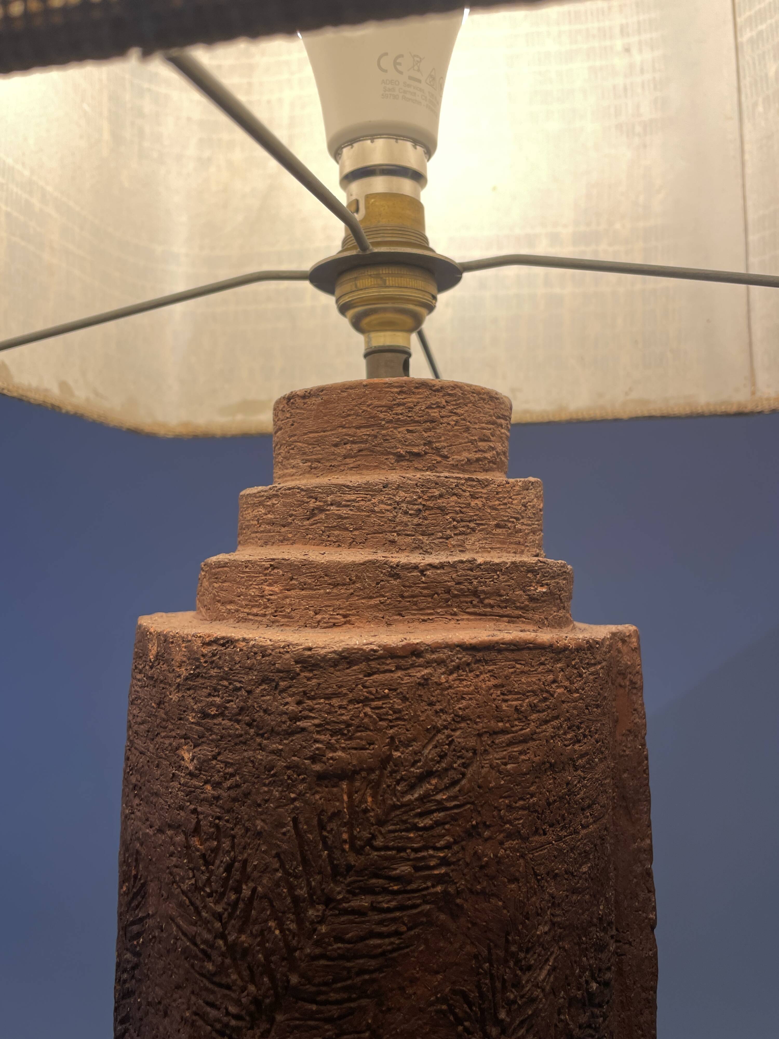 Large chamotte clay lamp in brutalist style, with a plant motif.