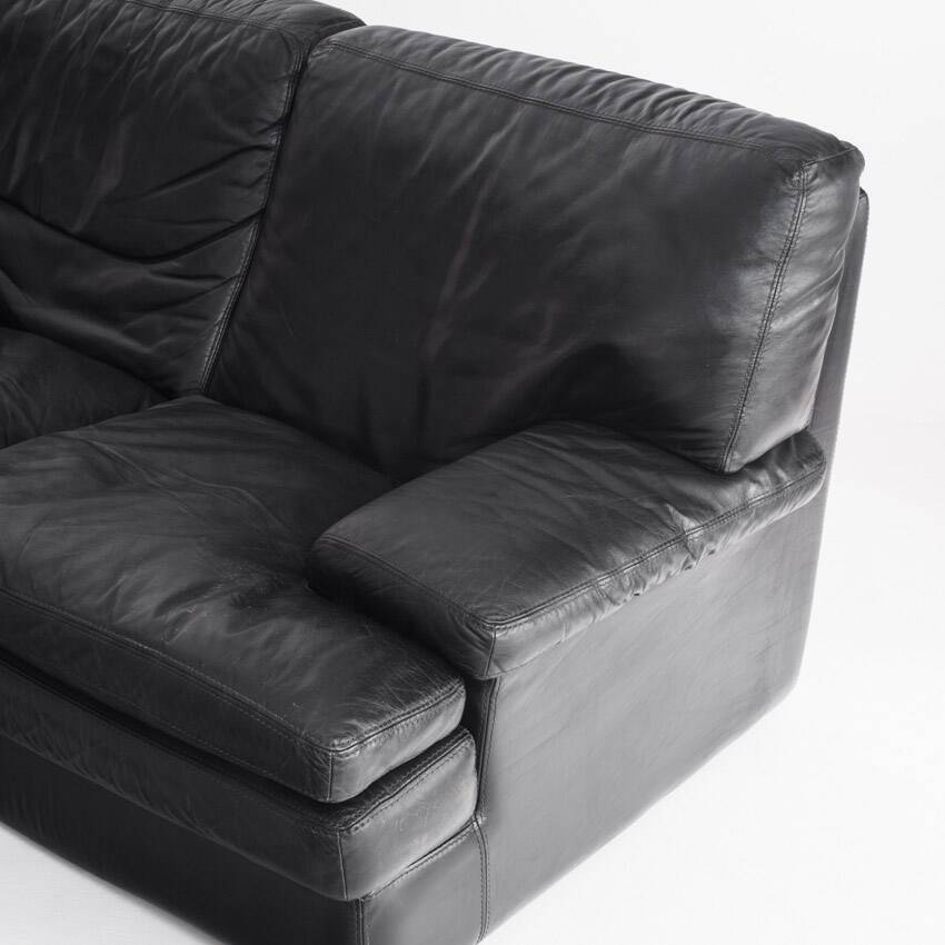 Black leather two-seater sofa. Roche Bobois edition. France, 1980s.