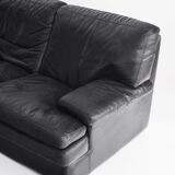 Black leather two-seater sofa. Roche Bobois edition. France, 1980s.