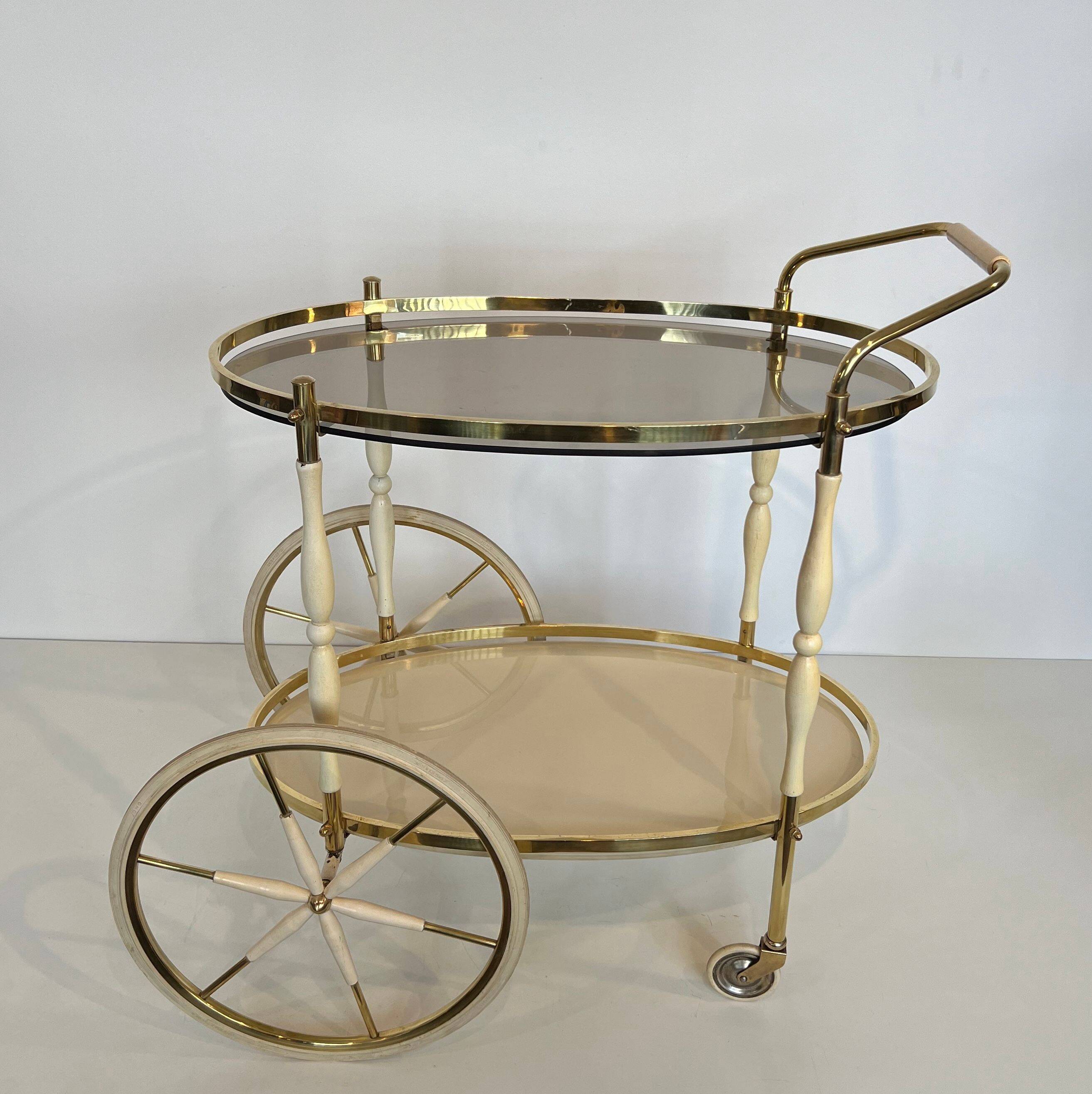 Italian oval rolling table in brass and lacquered wood.