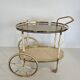 Italian oval rolling table in brass and lacquered wood.