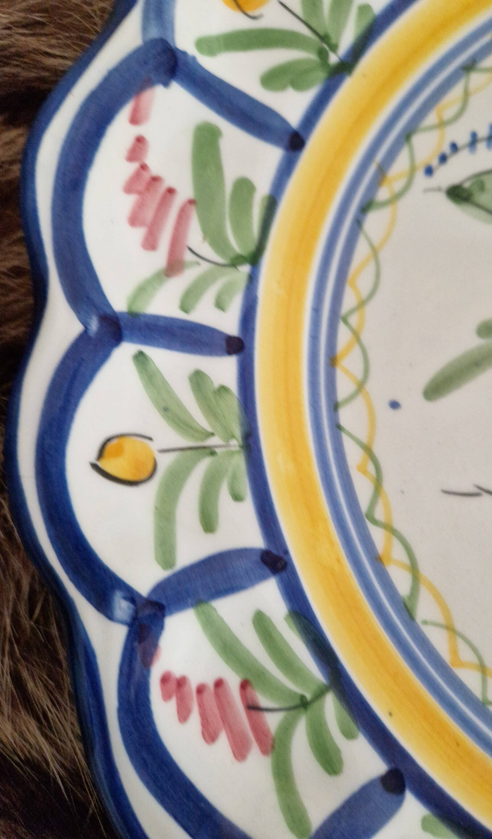Large hand-painted French faience plate with floral decoration in folk art style.
